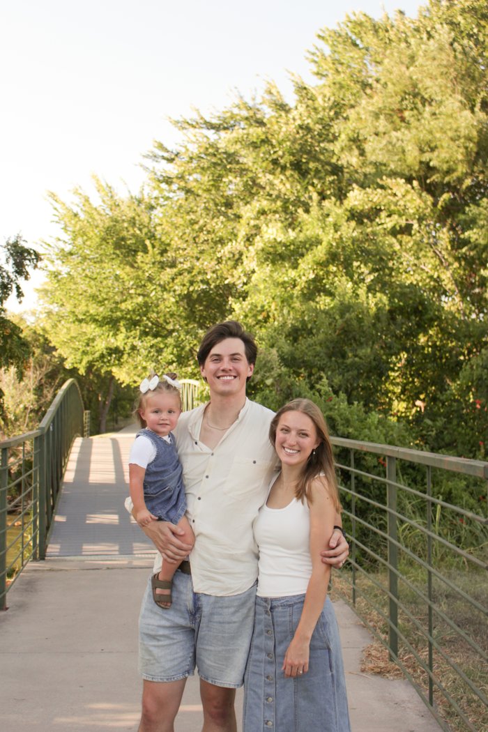 Seth with his wife and 18-month-old daughter on a footbridge